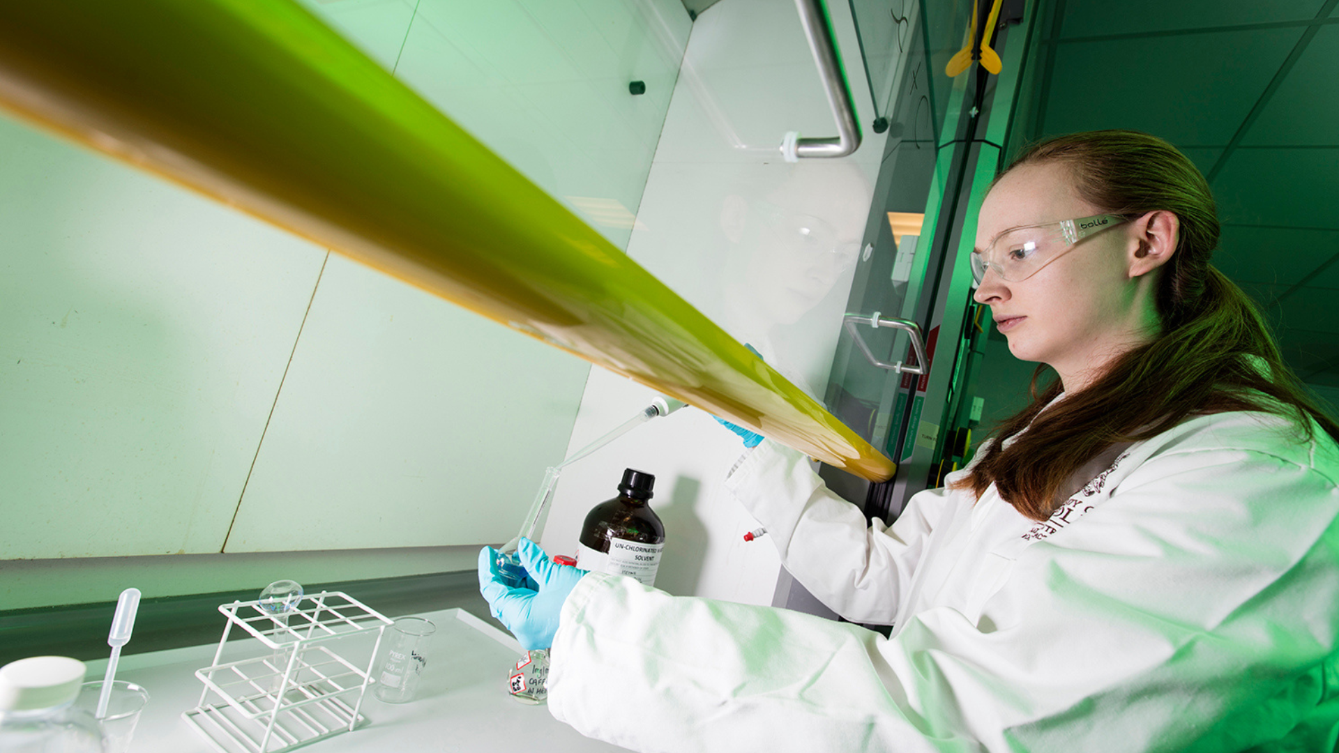 Student with pipette and conical flask