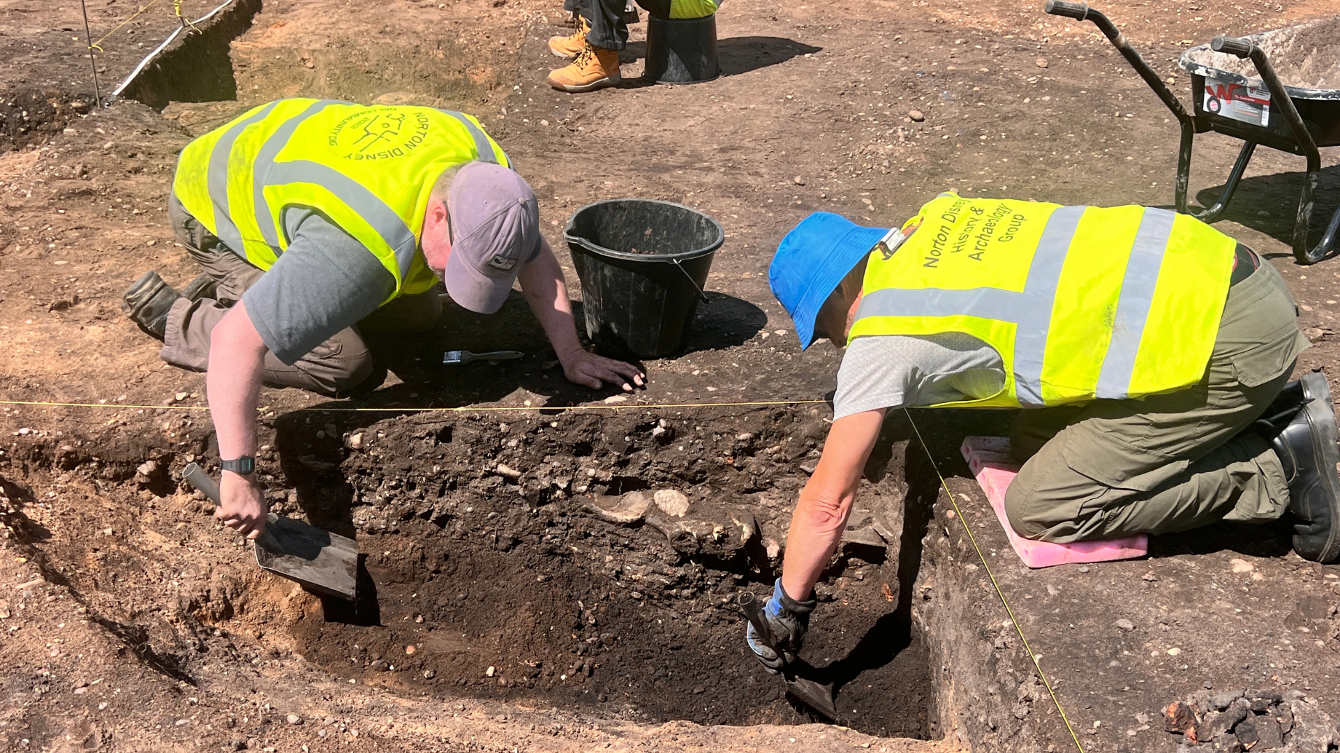 Two members of the Norton Disney History and Archaeology group take part in a dig.