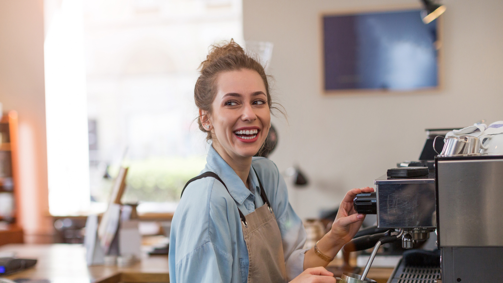 A lady working on a coffee machine