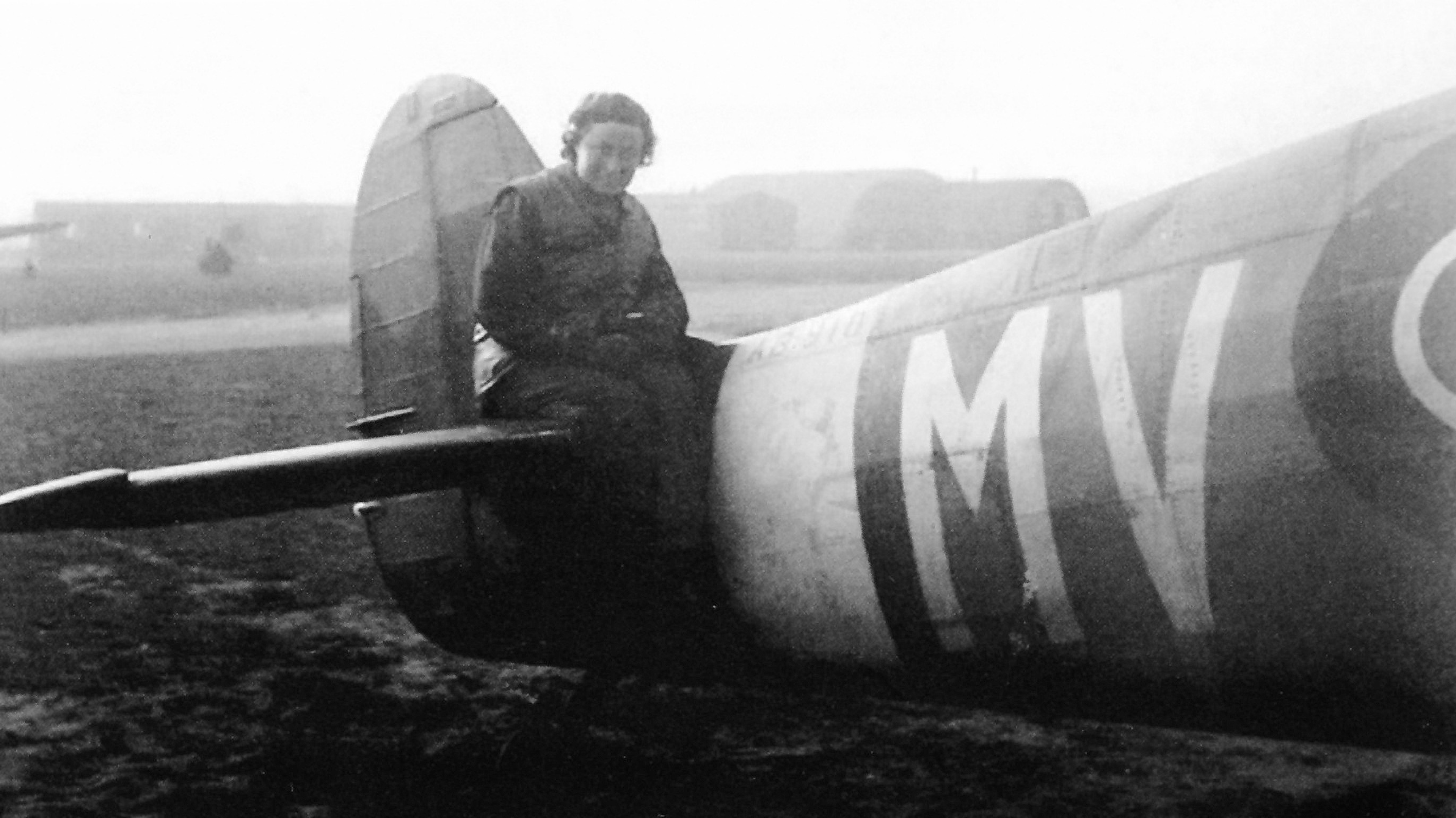 Margaret Horton sitting on
the tail of a Spitfire