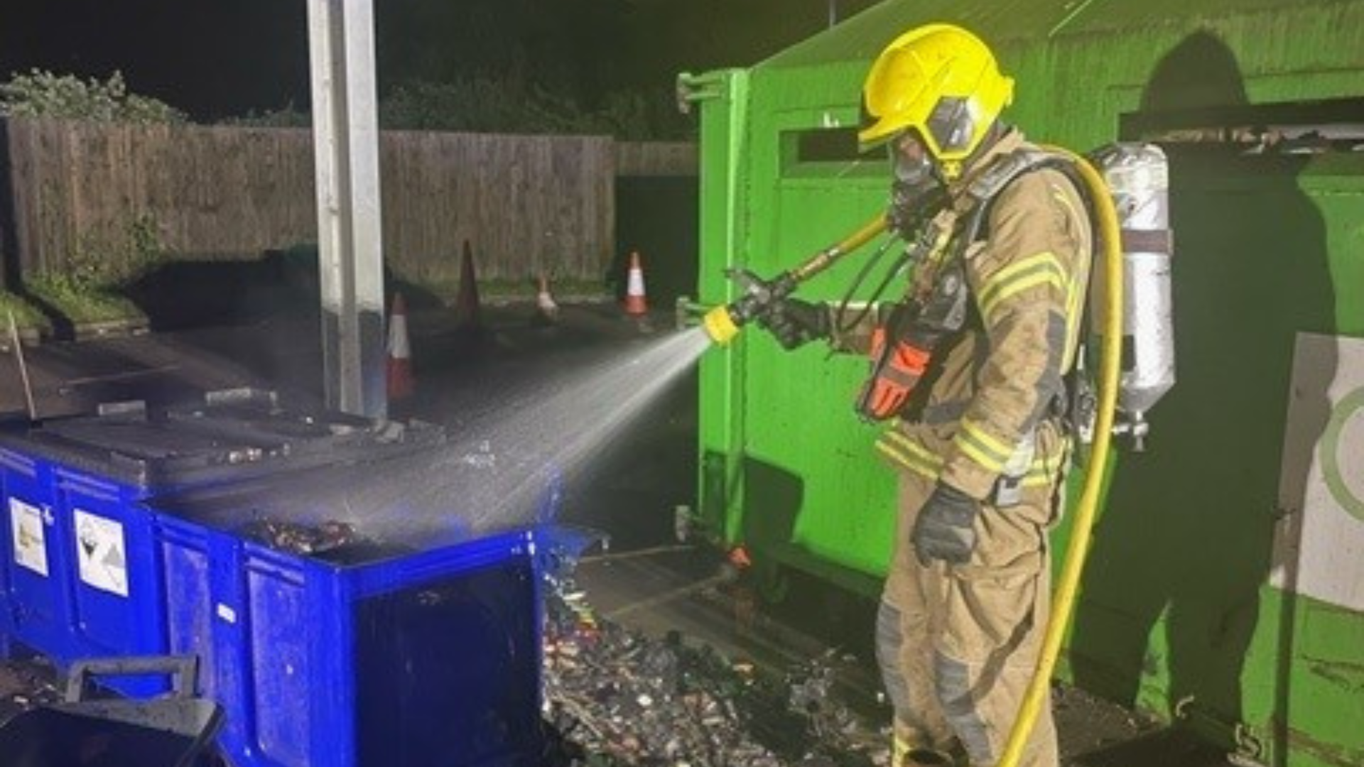 Firefighter extinguishing a fire caused by batteries