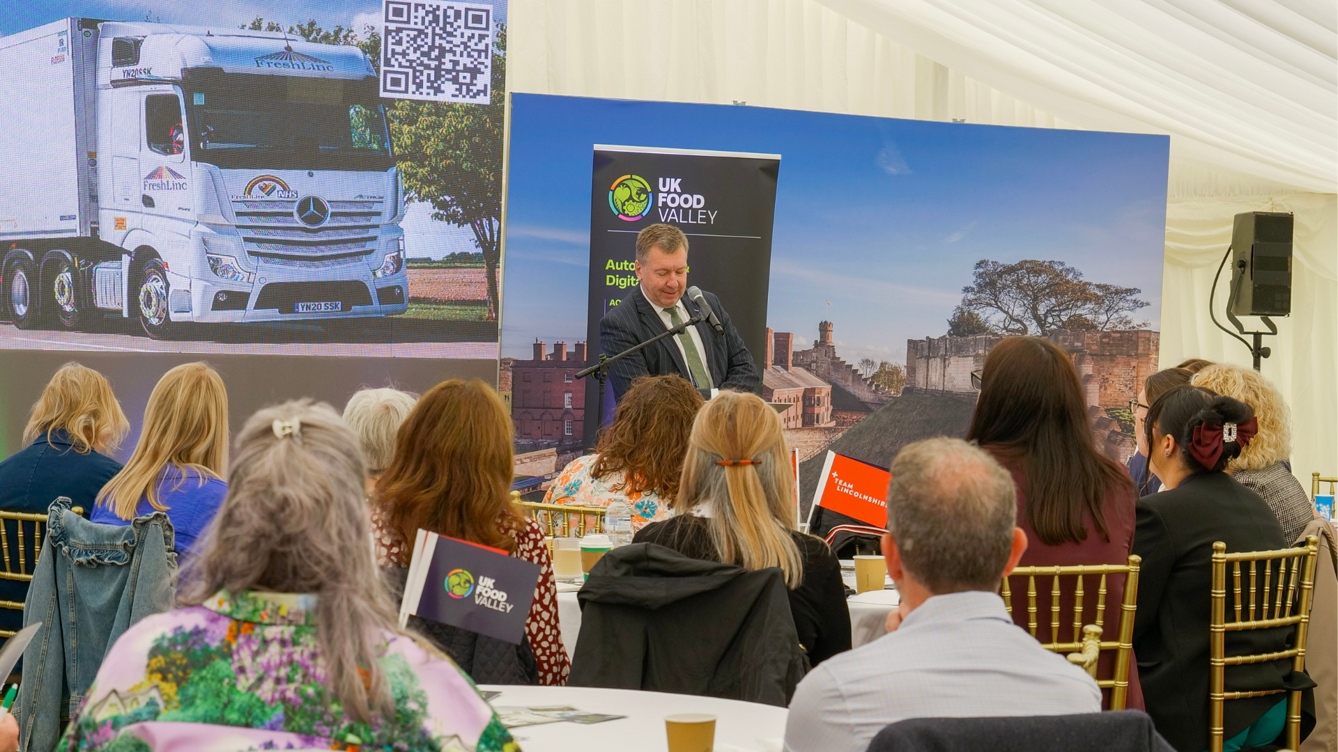 Councillor Sean Matthews speaking in front of people at an event