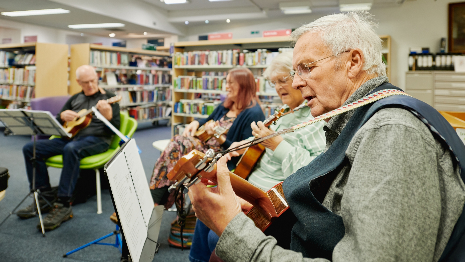 Men and women playing ukuleles in Sleaford Library