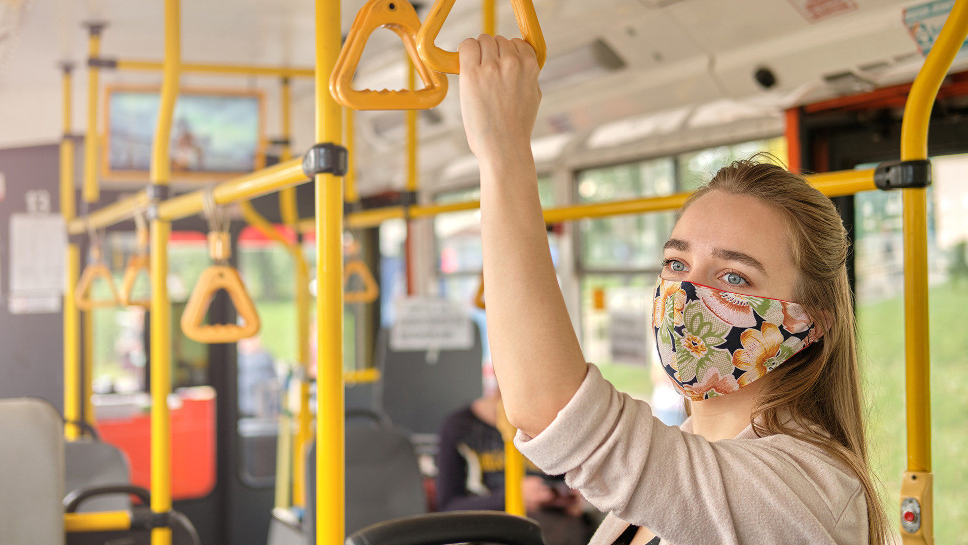 Woman on bus wearing face covering