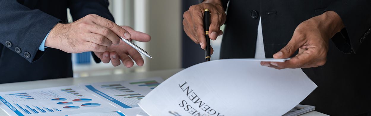 Image of two men looking at paperwork