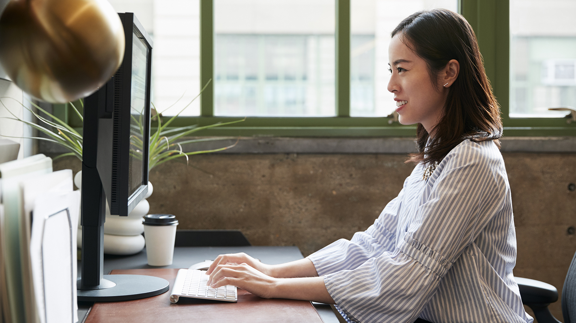 Chinese woman working at a computer in an office