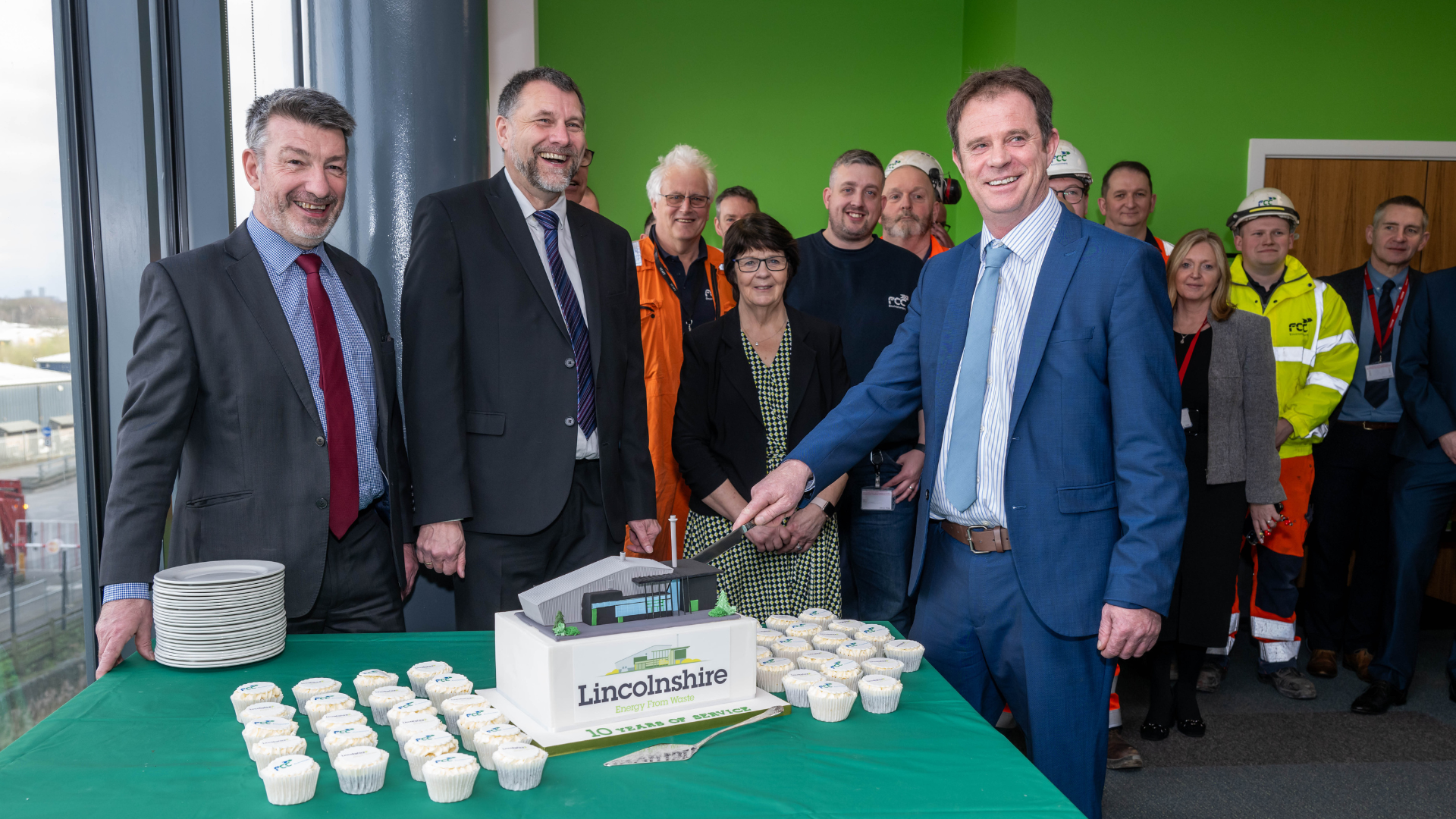 Cllr McNally cuts a cake shaped like the EfW facility