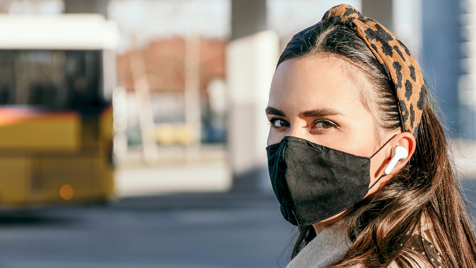 Girl waiting for bus in mask