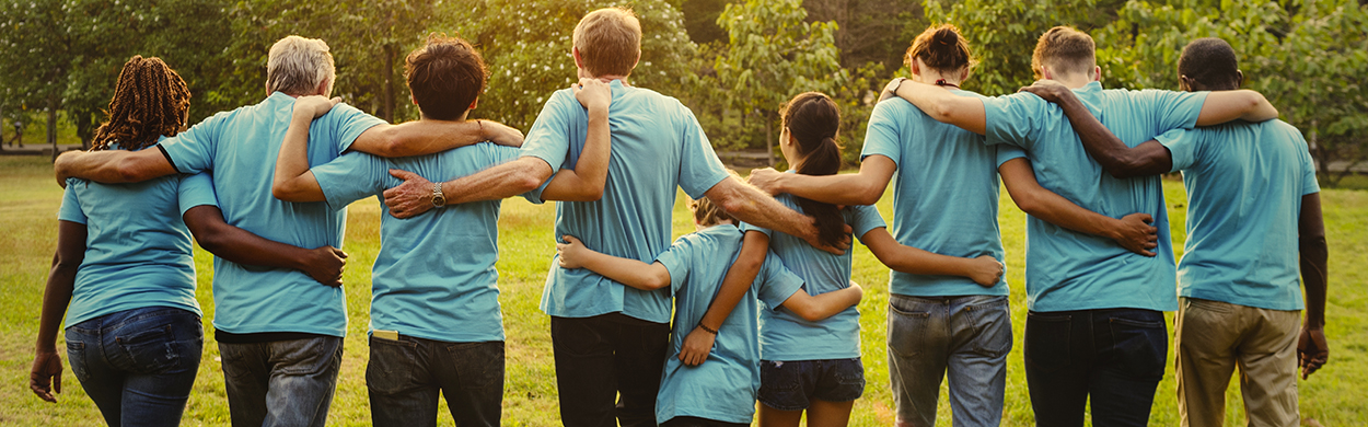 Image of volunteers with their arms around each other
