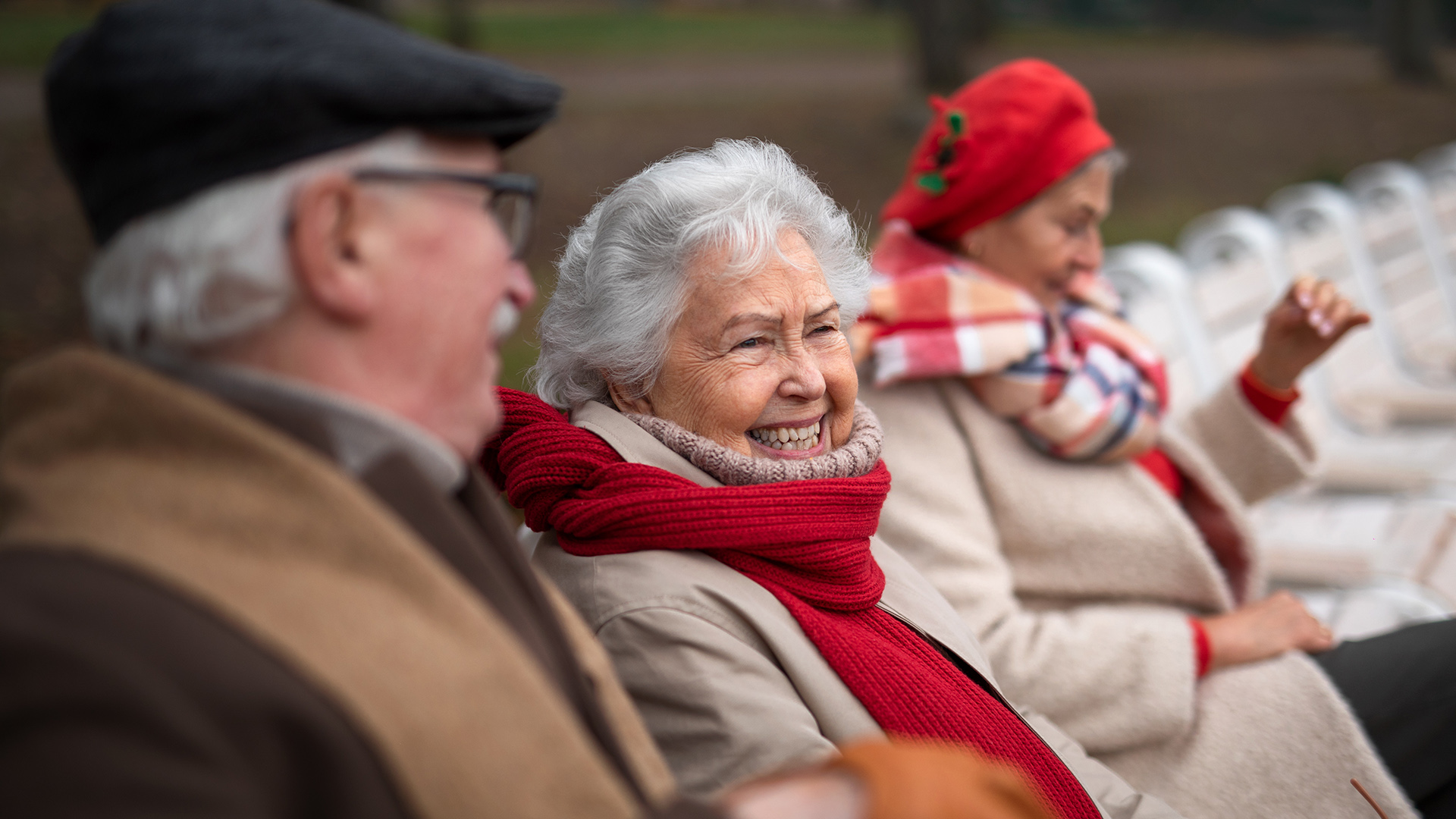Image of a group of happy senior friends sitting on bench