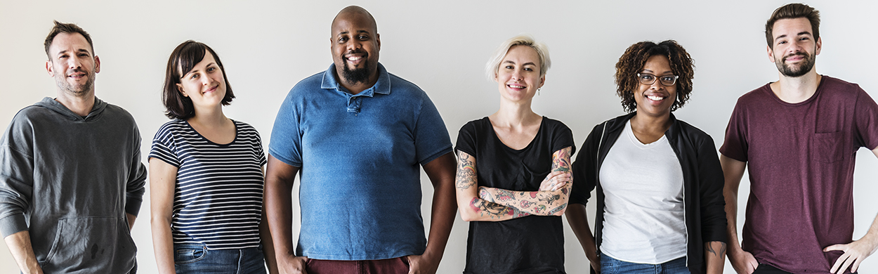 Image of a diverse group of people standing against a wall