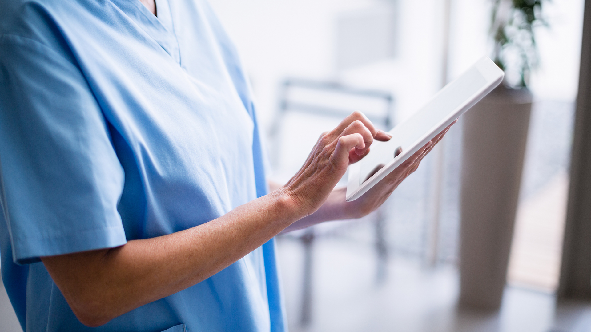 Image of a nurse with digital device