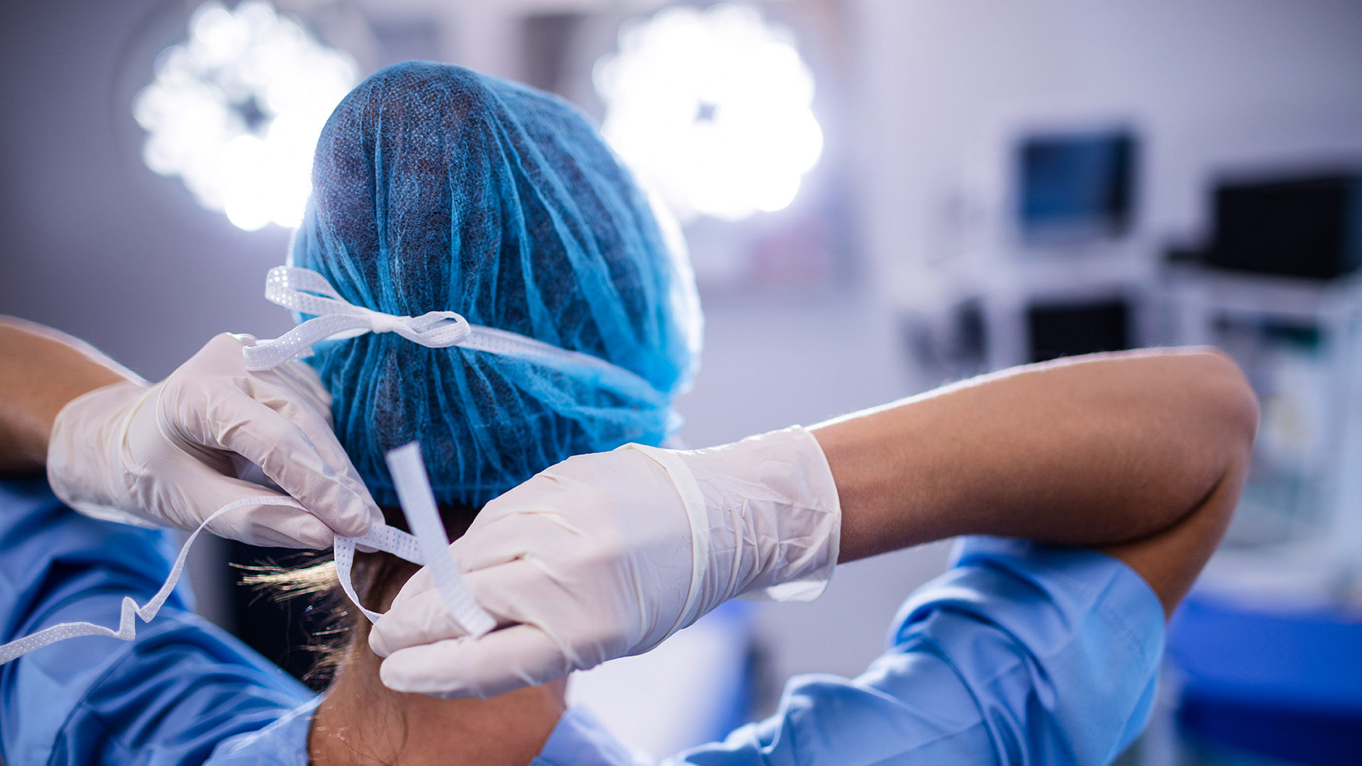 Nurse tying mask