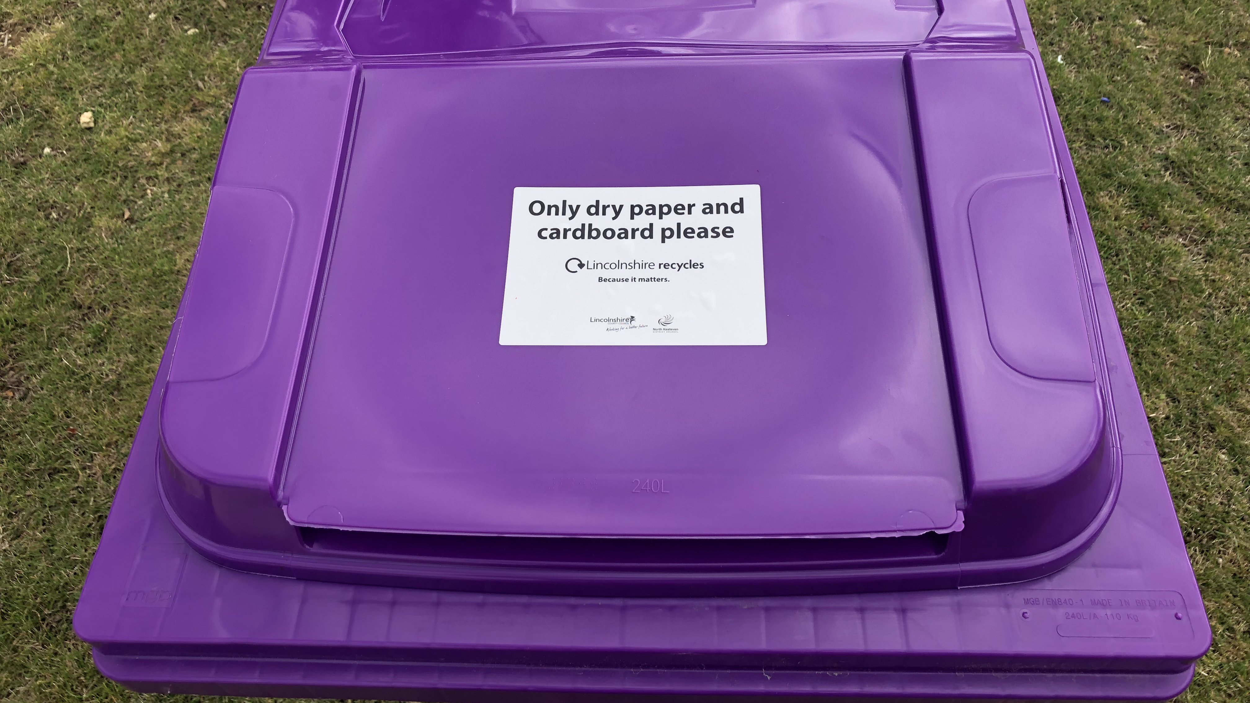 Close up of purple bin and trial label on the lid, asking for just card and paper
