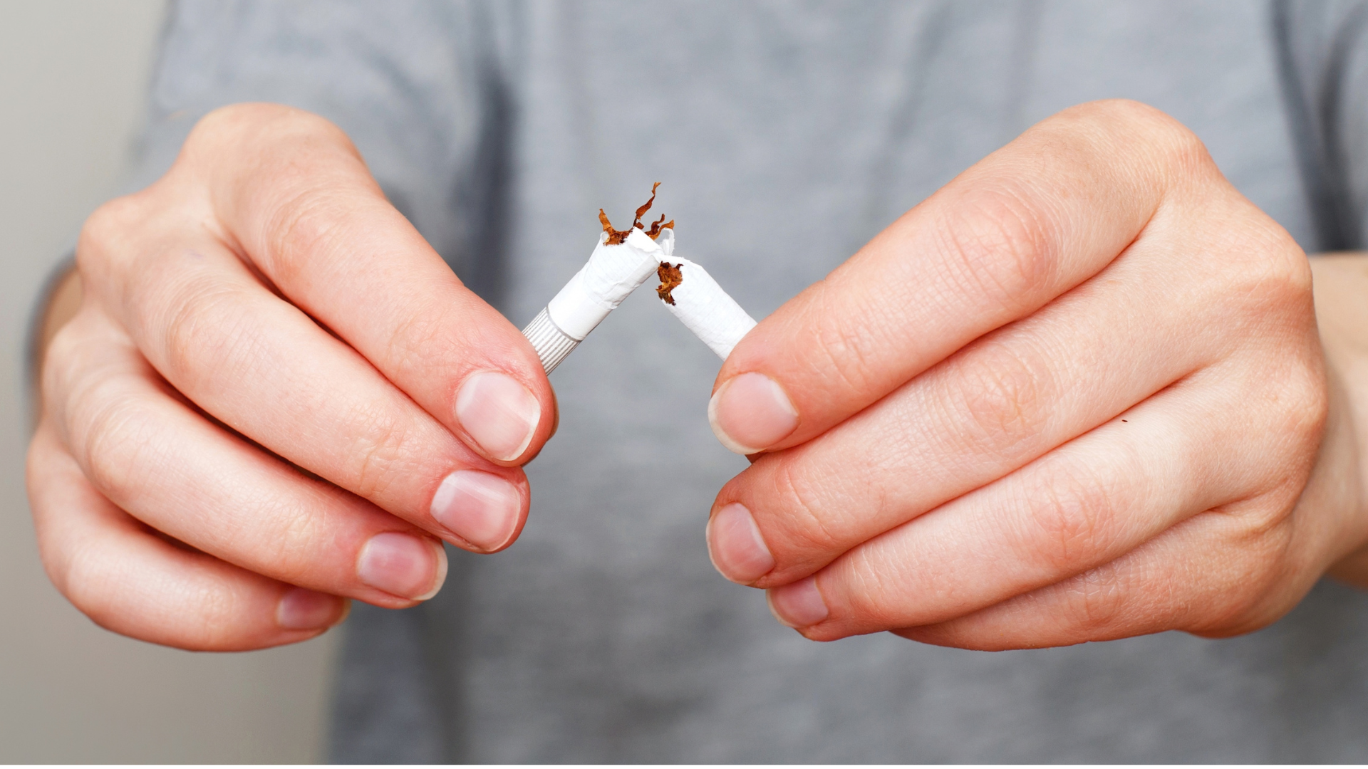 Hands snapping cigarette in half